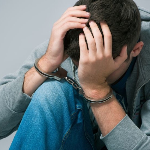 teenager on handcuffs